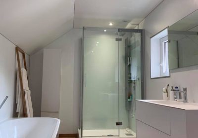 Plafond tendu blanc mat en deux versants dans une nouvelle salle de bains